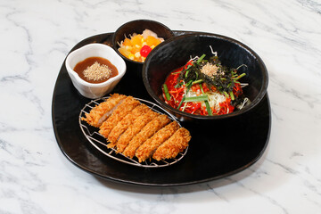 Korean Spicy Noodles and pork cutlet set on bright background.
