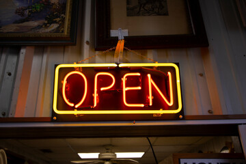 A beautiful, glowing neon Open sign an entrance 