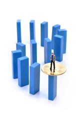 Miniature people figure businessman stand on top of blue domino block with bitcoin.  