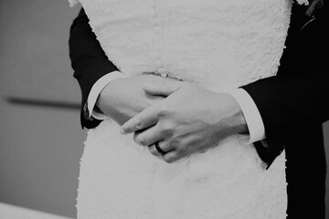 groom's hands around bride's waist