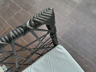 Closeup detail of outdoor furniture with rattan, Dark texture surface of chair, Artificial rattan pattern.