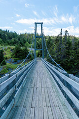 The suspension bridge in the ghost town of La Manche, Newfoundland has been reconstructed since the town was abandoned due to a flood in the 1960s. - obrazy, fototapety, plakaty