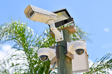 Multiple security cameras on a post watching every move