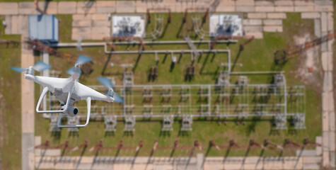 Naklejka premium Electrician use industry drone inspections electric power station electricity high voltage transmission tower, top view