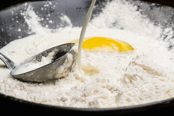 step by step batter mix for pancakes flour milk and egg