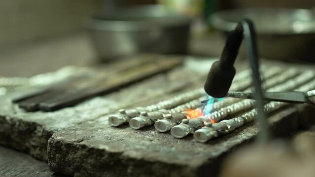 Jeweler at work in jewelry. Desktop for craft jewelry making with professional tools. Close up view of tools. Thailand. 