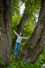Naklejka na ściany i meble a woman climbing a tree