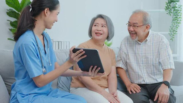 Asian caregiver nurse examine senior woman patient and husband at home