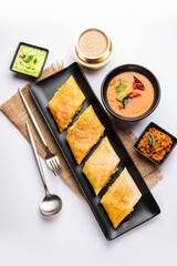 Cut Masala dosa or spring dosa is a South Indian meal served with sambhar and coconut chutney.
