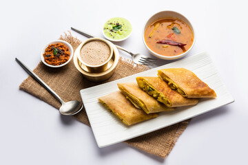 Cut Masala dosa or spring dosa is a South Indian meal served with sambhar and coconut chutney. - obrazy, fototapety, plakaty