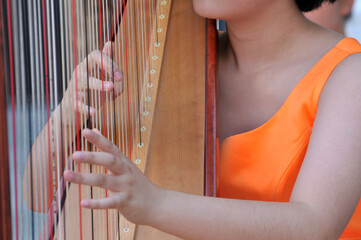 a chinese girl playing the harp	