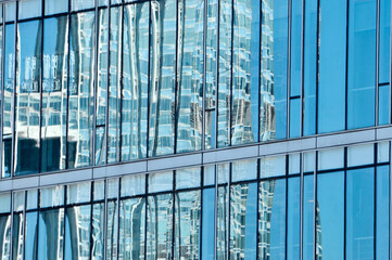 The glass windows of the building in sunset