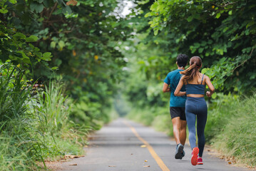 Obraz premium Asian couple, they are jogging and exercising.