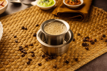 South Indian Filter coffee served in a traditional brass or stainless steel cup - obrazy, fototapety, plakaty