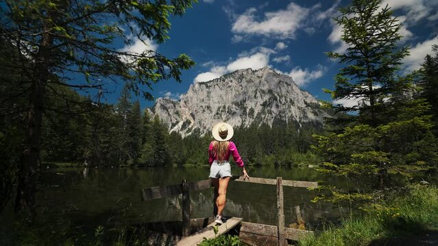 Tourist girl at Gruner See, beautiful green lake with crystal clear water in summer, Gruner See, Styria, Austria
