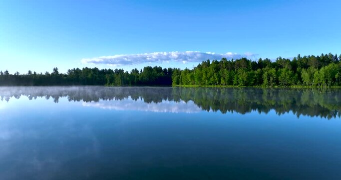 Beautiful Drone Shot of Blue Lake Water in Grayling Michigan.