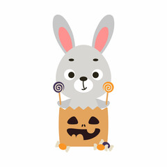 Cute Halloween rabbit sitting in a trick or treat bag with candies. Cartoon animal character for kids t-shirts, nursery decoration, baby shower, greeting card, invitation. Vector stock illustration