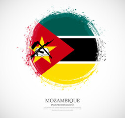 Creative circular grungy shape brush stroke flag of Mozambique on a solid background