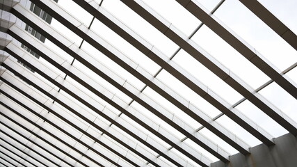 Modern slatted roof. Close-up of concrete slat roof for sunshade
And there's sunlight shining down on the view below. Selective focus