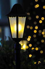 street lamp and Colorful out of focus Christmas tree lights blurred