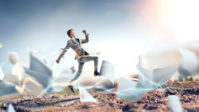 Portrait of energetic businessman jumping in open air