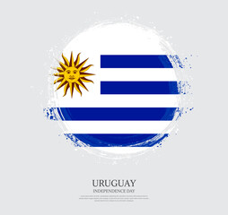 Creative circular grungy shape brush stroke flag of Uruguay on a solid background