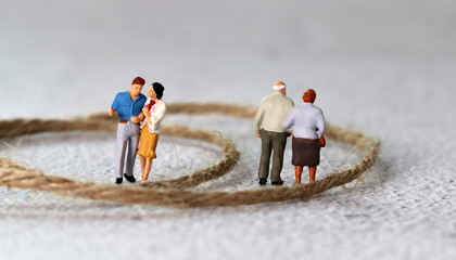Rope and miniature people. The concept of generational conflict.
