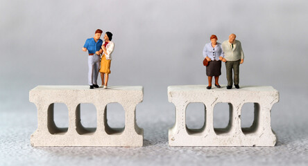 Brick and miniature people. The concept of generational conflict.

