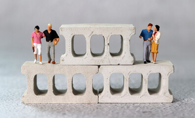 Brick and miniature people. The concept of neighborhood discord.
