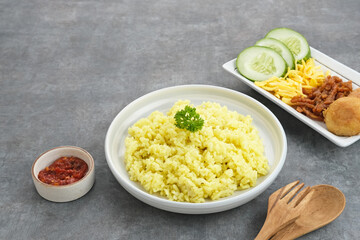 Nasi kuning, Indonesian traditional food, made from rice cooked with turmeric and coconut milk and spices.
