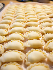 dumplings or ravioli on a tray, homemade food