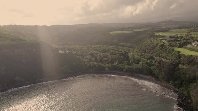 We say goodbye in this aerial to Maul, Hawaii. Glowing sunset, lapping waves, some sun flare on the lens, and a smile on the face. We hope you think of us for your next vacation in paradise