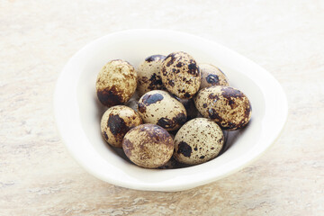 Raw quail eggs heap in the bowl