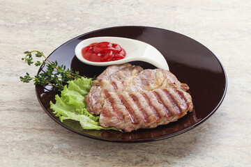 Grilled pork neck steak with ketchup