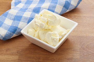 Italian soft mascarpone cheese in the bowl