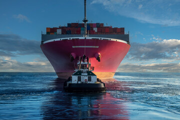 Tugboat towing container ship
