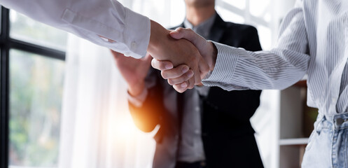 Fototapeta na wymiar Business handshake for teamwork of business merger and acquisition,successful negotiate,hand shake,two businessman shake hand with partner to celebration partnership and business deal concept