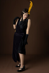 1920s woman wearing an evening gown and a head band with a large feather