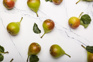 Fresh pears on light  marble background, flat lay composition