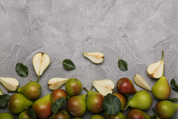 Ripe juicy pears on light cement  table, top view. Space for text