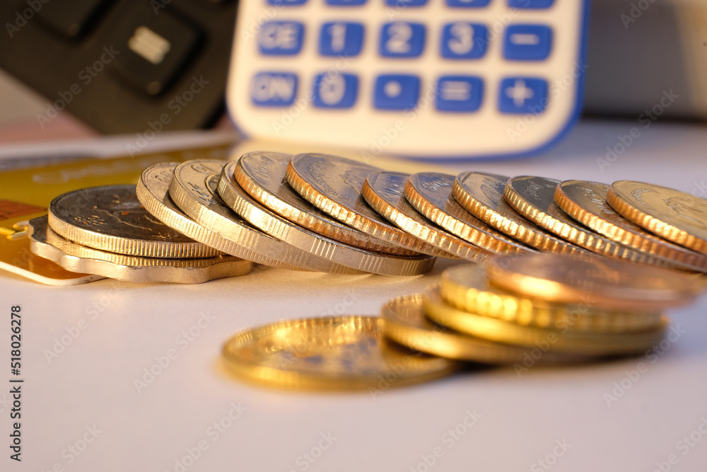 Poster close-up of a coin stack on a table with a business or finance saving money.