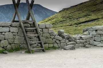 Rural Ireland wooden ladder over stone wall in the mountains