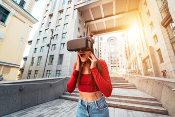 Woman in a virtual reality helmet walks down the street