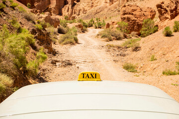 sign of a taxi on an off-road jeep bringing people up in a mountainous area