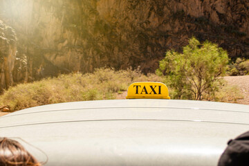 sign of a taxi on an off-road jeep bringing people up in a mountainous area