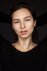 Fototapeta premium Closeup portrait of a young and cute beautiful woman, isolated black background.