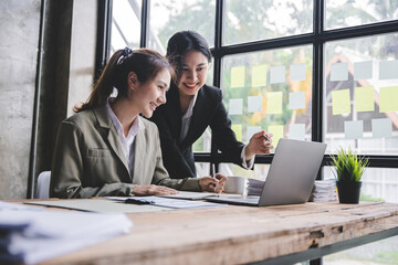 Young colleagues discussing business and price chart analyzes business people on the table great in modern coworking office teamwork concept.