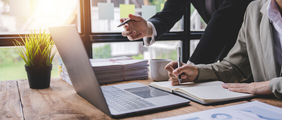 Young colleagues discussing business and price chart analyzes business people on the table great in modern coworking office teamwork concept.