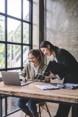 Young colleagues discussing business and price chart analyzes business people on the table great in...