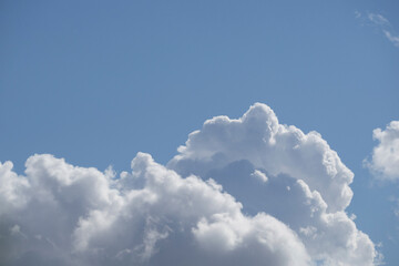 A big fluffy white cloud in the blue sky. Sky clouds. Cloudy sky